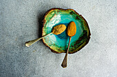 Vintage spoon with powdered spices such as ginger and turmeric