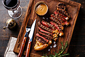 Grilled sliced Steak Striploin with Pepper sauce close-up