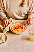 Butternut squash and tomato soup with bread and juice with your hands