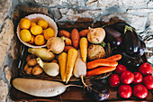 Fresh fruit and vegetables displayed on a wooden surface