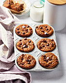 Vegan banana chocolate chip muffins in a muffin tin