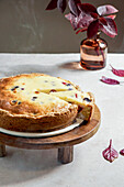 plum cake in asian style minimalism, soft light, white linen tablecloth