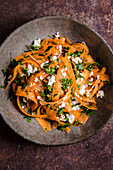 Carrot and feta salad on a rustic background