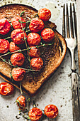 Toast with roasted tomatoes on a plate
