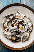 Shellfish Mussels Clams with cheese creamy sauce close-up