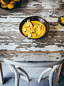 A lemon dessert smoothie bowl with edible flowers