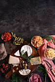 Healthy probiotic cheese platter served with kimchi, dark dye sourdough bread, and fermented vegetables, with negative copy space.