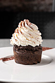 Chocolate and carob cupcake with whipped cream