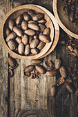 Fresh pecans and broken shells on a rustic wooden background
