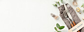 Easter table decorations. Stylish Easter brunch table setting with vintage cutlery, easter eggs and spring branches on light grey background top view flat lay copy space