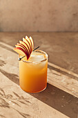 Spiced apple drink with sliced apple garnish.