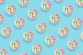 Modern retro colour pattern of pastel sweets against an aqua blue background