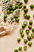 Kiwi berries on a beige background with fabric bag