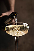 Prosecco pour into coupe glass