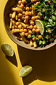 The dish of chickpeas and asparagus beans is flavoured with a slice of lime and chopped parsley. View from above