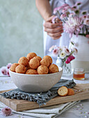 Doughnuts in a bowl on a napkin and cutting board