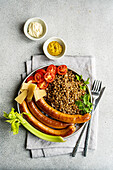 Healthy lunch bowl with buckwheat and sausages served on the table