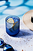 Sparkling water by the pool on a speckled background