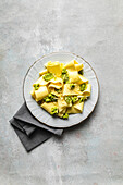 Plate of appardelle with pesto on the table