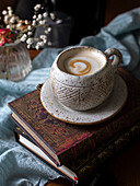 Cup of coffee on old books