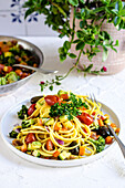 Spaghetti with crispy vegetables and turmeric on a plate