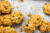 Cornflakes, sultanas and peanut biscuits on a baking tray