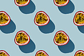 Horizontal pattern of tropical exotic passion fruit on blue background flatlay food