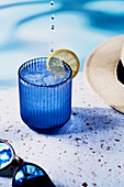 Sparkling Water by the Pool on speckled background