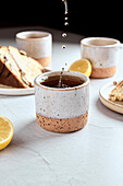 Black Tea with Lemon in Small Ceramic Mugs