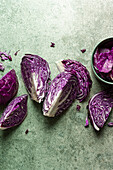 Purple cabbage slices on a green background