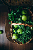 A selection of healthy green foods, including apples and kale
