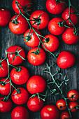 Red cherry tomatoes on a wooden background
