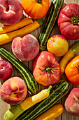 Tomatoes, Zucchini and Stone Fruit on a Wood Background