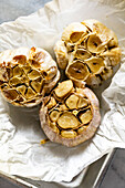 Home baked garlic cloves on paper