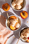 Frozen yoghurt with nectarines in three bowls