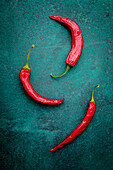 Chilli peppers on a green background