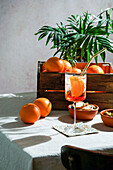 aperol spritz, cocktail, on a linen tablecloth, shadows, hard sunlight, summer drink in glass