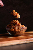 Healthy Japanese-style probiotic miso against a dark background. Female hand with spoon