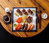 Sashimi and Nigiri sushi set on wooden table