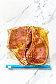 Pork chop marinating in olive oil,garlic and spices