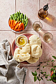 Pita Bread and Hummus on Pink Tile