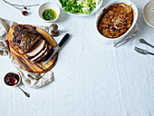 Dinner with slow roasted pork, potatoes and salad. Flatlay with copy space