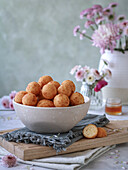 Doughnuts in a bowl on a napkin and a cutting board