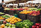 Bazaar with various ripe fruits and vegetables in grocery basket in market stall in Morocco