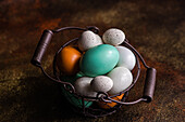 From above basket with easter card concept with eggs on rustic brown background