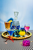 Different varieties of cocktails comprising blue margarita Long Iceland iced tea wine daiquiri in attractive glasses and jar placed on plate on striped cloth against blue background