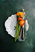 Top view of Table setting with Ranunculus flowers on concrete background