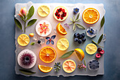 Background of beautiful fruit slices on frozen surface with ice shapes and flowers and leaves. Generative AI