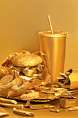 Golden street food spread on a table against a golden background