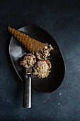 From above Balls of coffee and chocolate ice cream on black concrete background